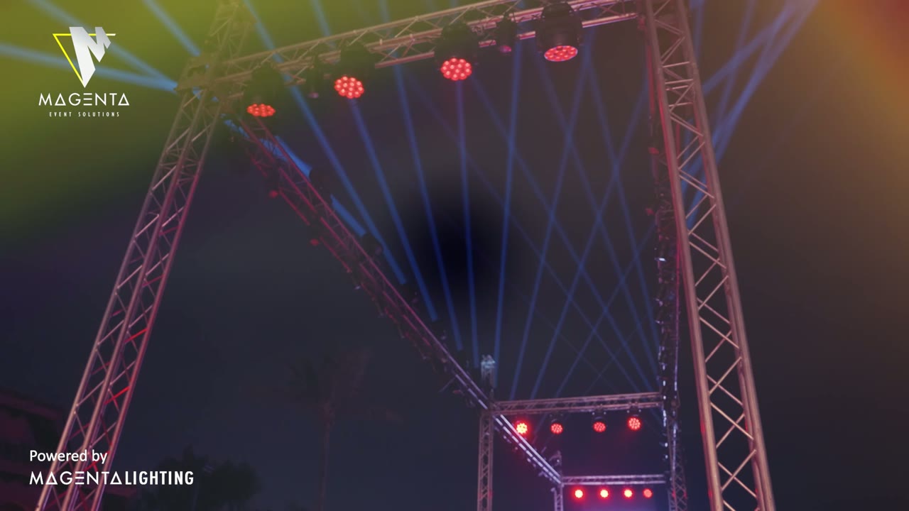 An evening at the Park Hyatt in Jeddah: guests below a lit truss rig, with beams crossing the room above the performance.