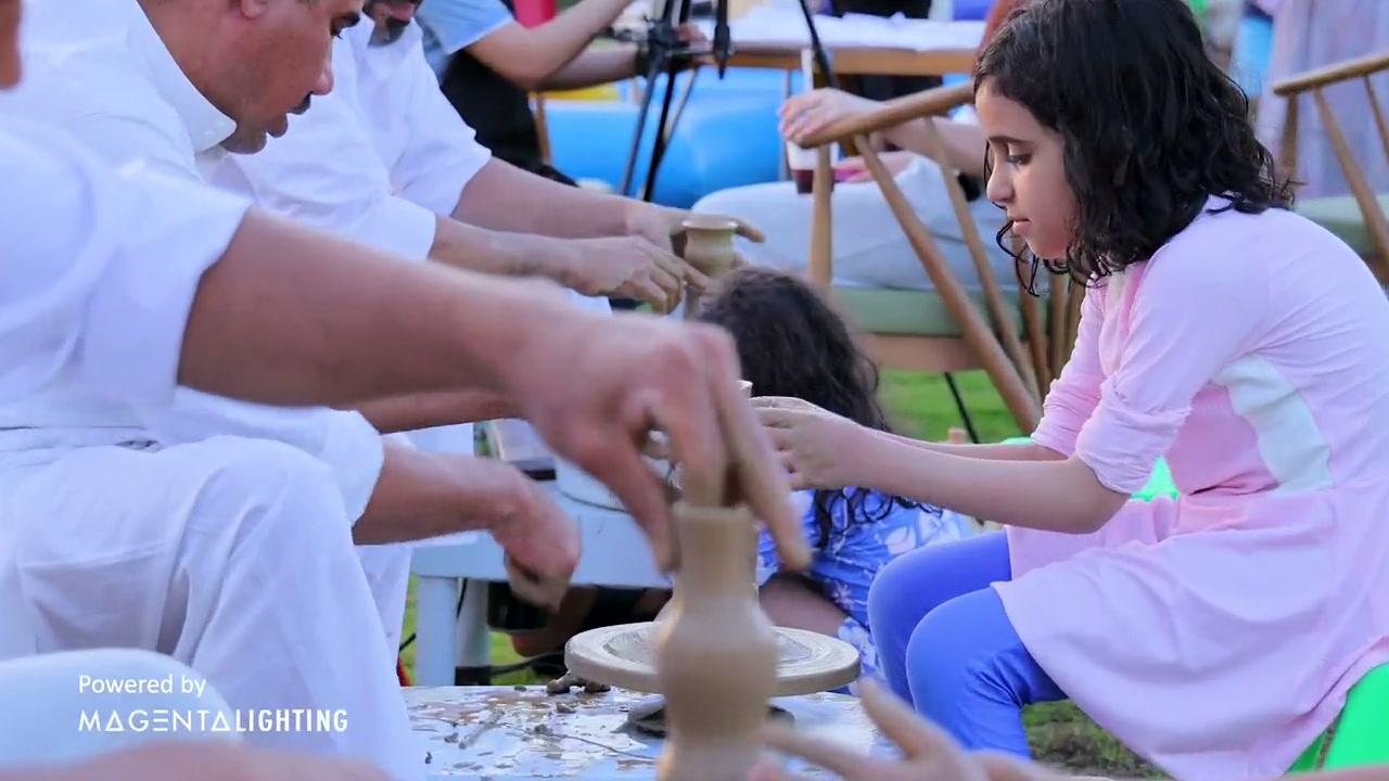 A family making pottery together at the Rixy Kids Club carnival in King Abdullah Economic City.